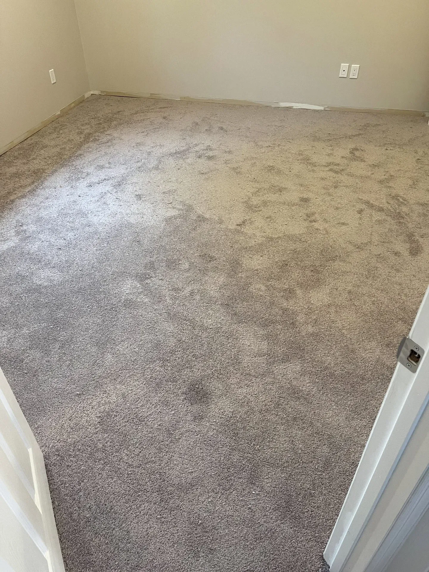Grey plush carpet installed in an empty room