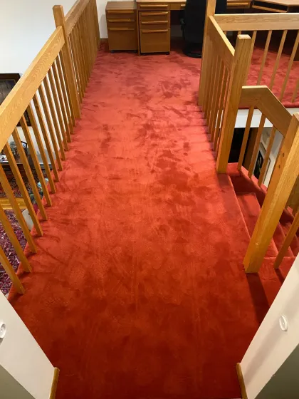Red carpet on an upstairs landing and hallway