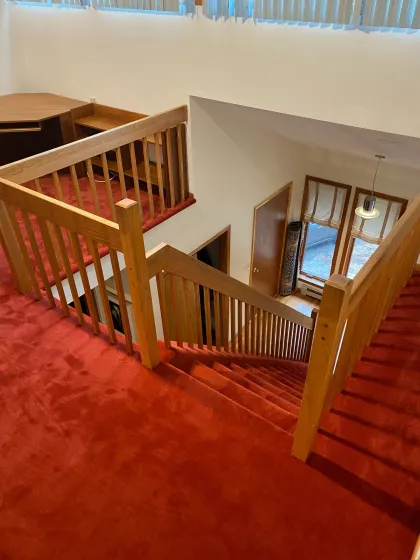 Red wall-to-wall carpet on an upstairs landing