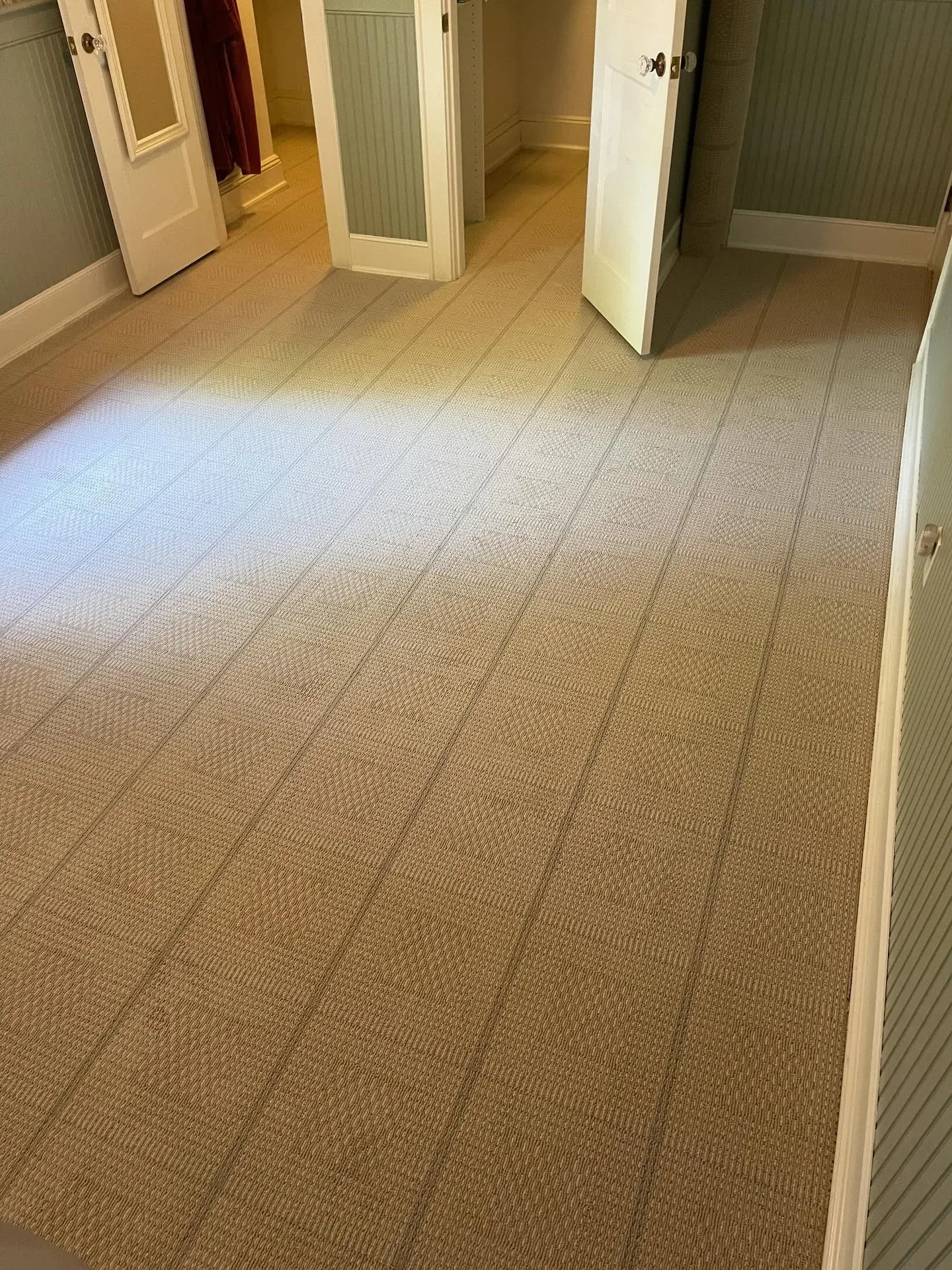 Sisal-look woven carpet installed in a dressing room with closet doors