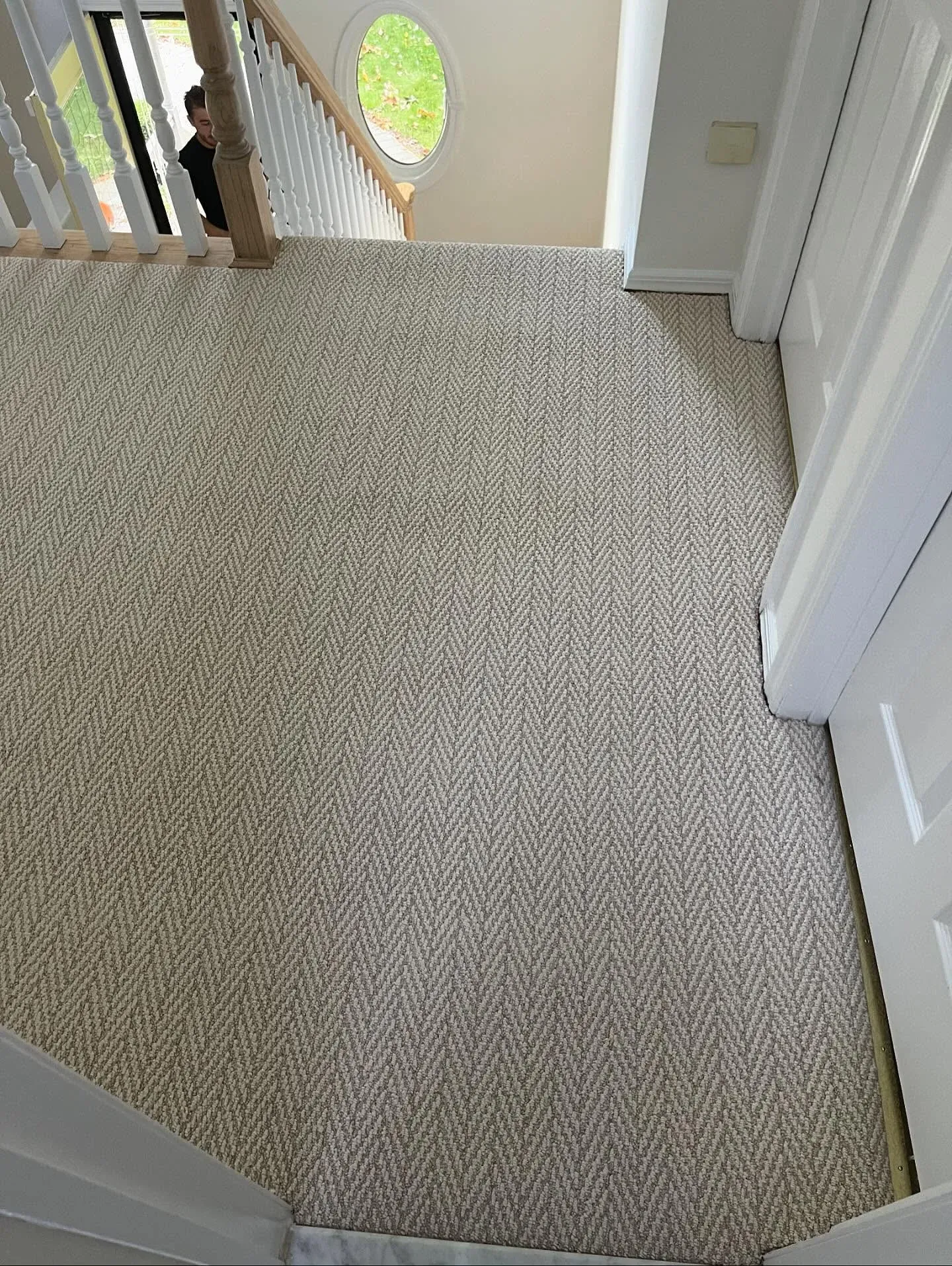 Textured wall-to-wall carpet installed on a second-floor landing