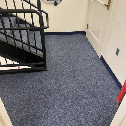 Blue-grey commercial carpet in a stairwell landing