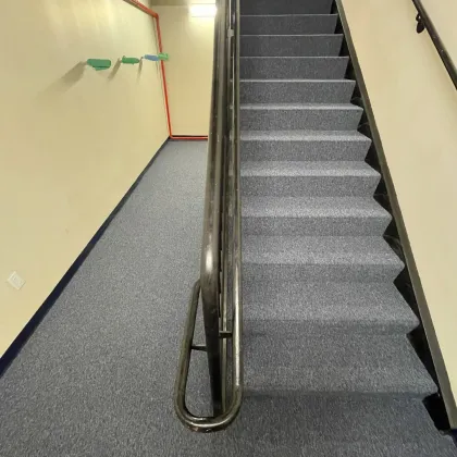 Grey commercial carpet installed on a stairwell