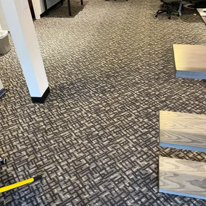 Commercial carpet tile installation underway in an open office