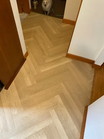 Herringbone luxury vinyl tile run through a hallway and doorway