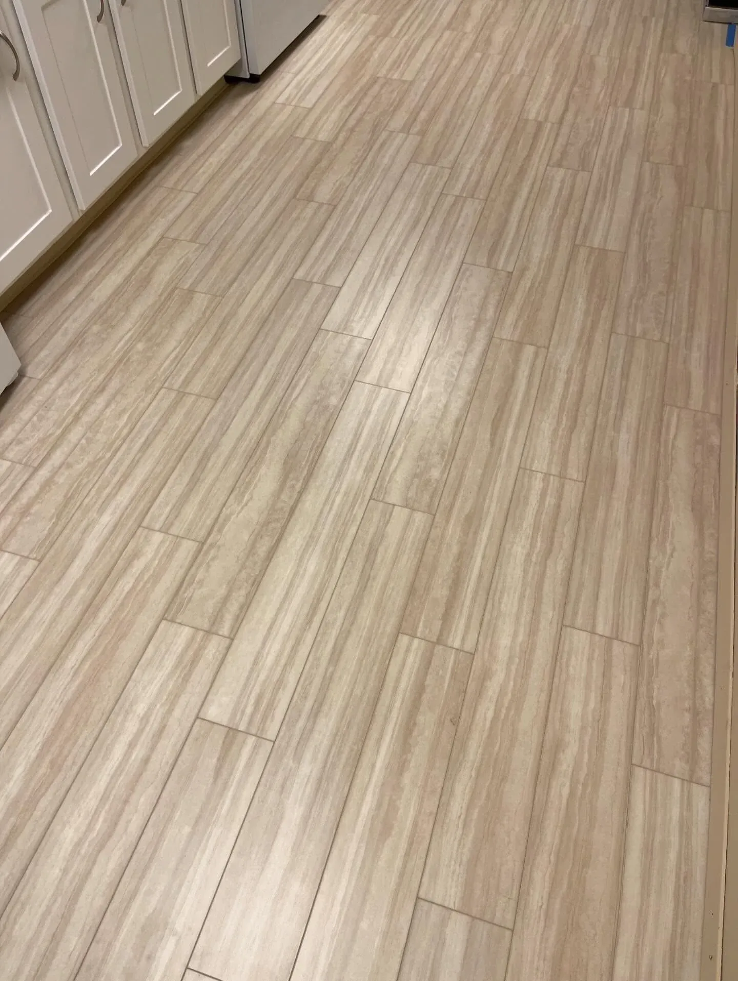 Light wood-look resilient plank flooring installed in a kitchen