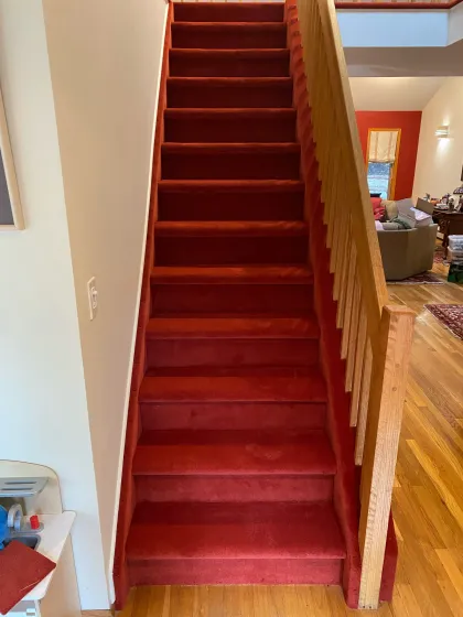 Red carpet installed on a straight staircase