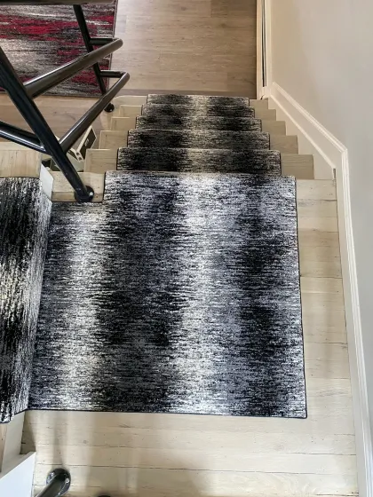 Stair runner and matching area rug on light plank flooring