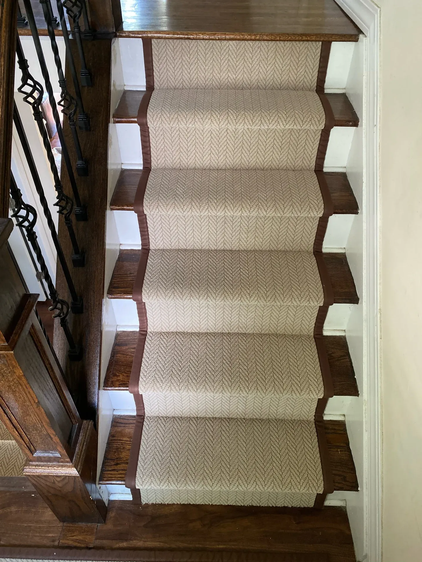 Cream stair runner on dark hardwood treads