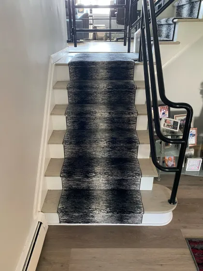 Modern abstract stair runner with a coordinating landing rug
