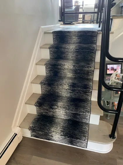 Abstract navy stair runner installed on a straight staircase