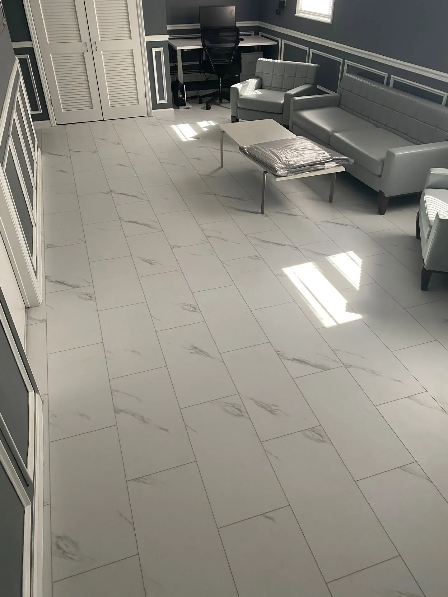 Marble-look tile flooring installed in an office reception area